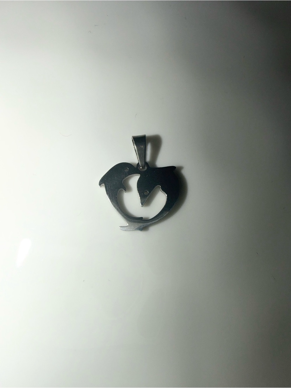 Silver pendant with two dolphins forming a heart shape #dolphins #heart